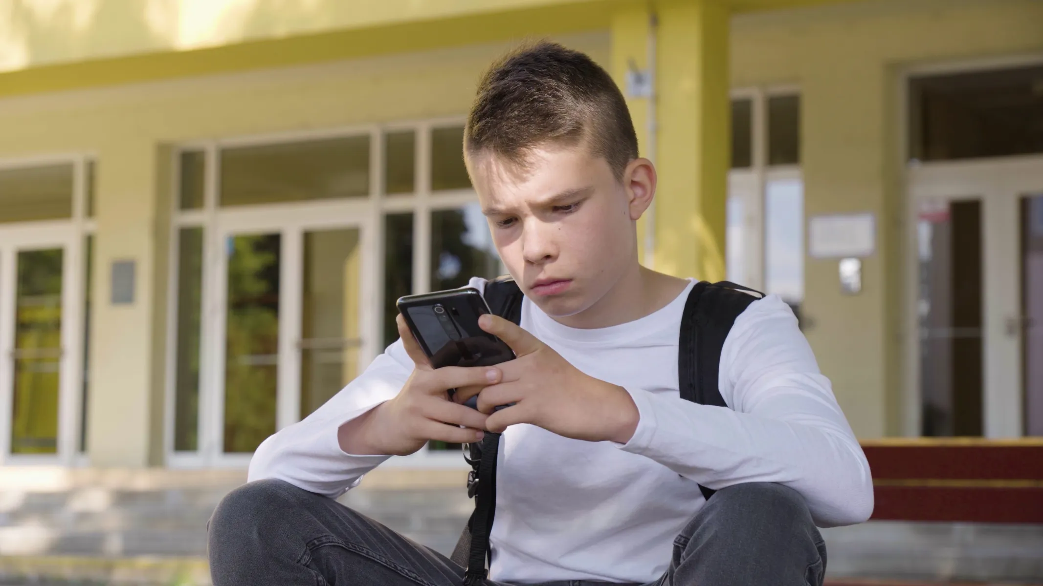 Boy Texting At Schools